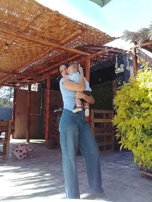 a man holding a baby on his arms at Samay77 Ica in Ica