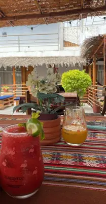 a table with two glasses and a drink on it at Samay77 Ica in Ica