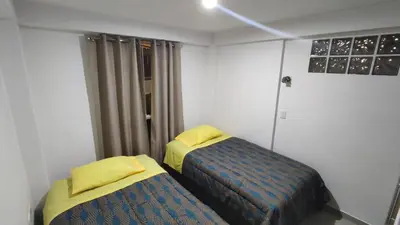 a room with two beds in a room at Apart Cusco 