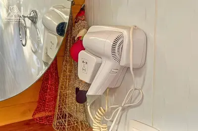 a hair dryer is hanging on a wall at Cabañas Alpinas en Oxapampa in Oxapampa
