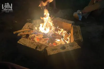 a fire is burning in a brick oven at Cabañas Alpinas en Oxapampa in Oxapampa