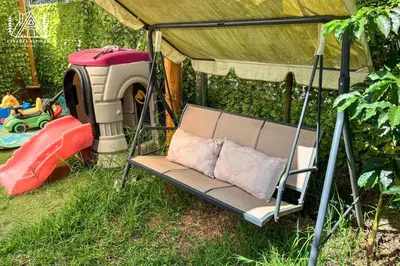 a swing bed in a tent in the grass at Cabañas Alpinas en Oxapampa in Oxapampa