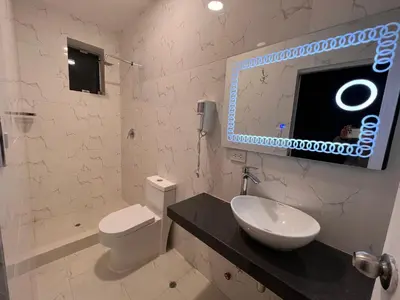a bathroom with a sink and a toilet and a mirror at Casona Plaza Hotel Cusco in Cusco