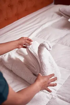 a person is drying towels on a bed at Casona Plaza Hotel Cusco in Cusco