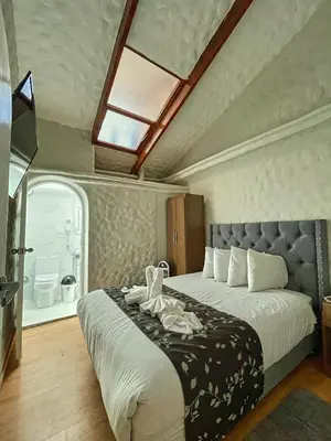 a bedroom with a bed with two towels on it at Casona Plaza Hotel Cusco in Cusco