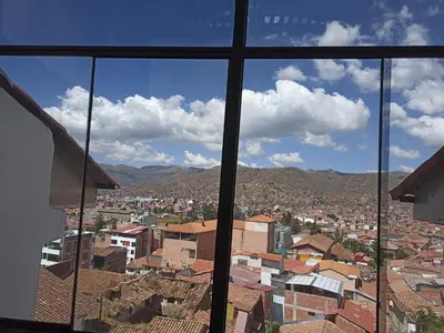 a view of a city from a window at Hostal Killaly Inn Cusco in Cusco