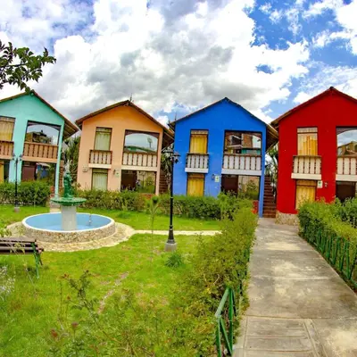 a group of houses painted in different colors at Mi Pueblito Lodge in Huancayo