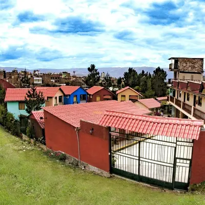 a group of houses with red roofs in a city at Mi Pueblito Lodge in Huancayo