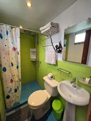 a bathroom with a sink and a toilet and a mirror at Barrio Inka B&B in Cusco