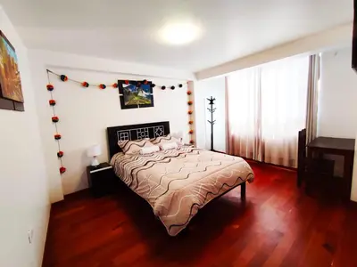 a bedroom with a bed in a room at Qolmay Hostel Cusco in Cusco