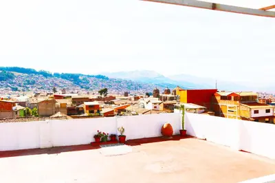 a view of a city from the roof of a building at Qolmay Hostel Cusco in Cusco