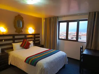 a hotel room with a bed and a window at SQ Estancia Del Inca in Cusco