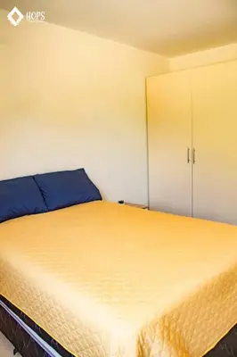 a bedroom with a bed and a cupboard at HOP LAGO & MAR exclusiva en playa de chincha in Chincha Baja