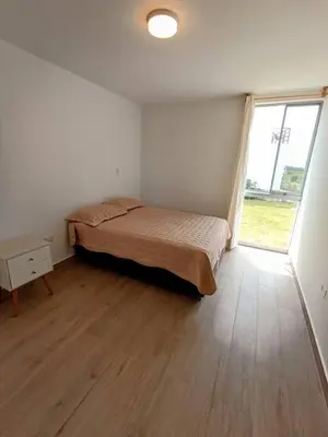 a bedroom with a bed and a large window at HOP ODAIBA exclusiva laguna y playa en Chincha in Chincha Baja