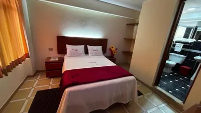 a bedroom with a bed and a large window at Hotel Los Arcos de Imperial in San Vicente de Cañete