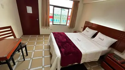 a bedroom with a bed and a desk and a window at Hotel Los Arcos de Imperial in San Vicente de Cañete