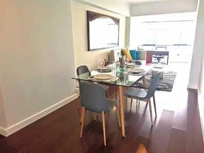 a dining table and chairs in a living room at Espacio Luxury Apartments Malecón 2 in Lima