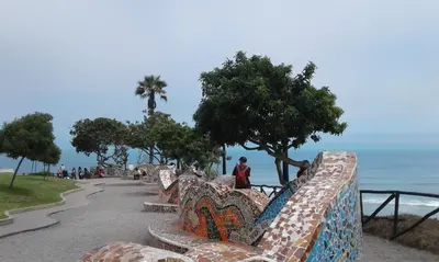a row of benches with a view of the ocean at NEREO rooms in Lima