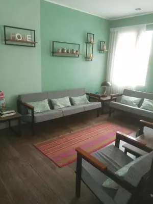 a living room with couches and tables in it at NEREO rooms in Lima