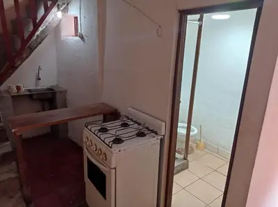 a small kitchen with a stove and a sink at CHINA SAQRA in Cusco