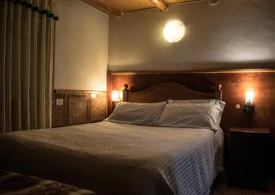 a bedroom with a large bed with a wooden headboard at Eco Lodge Los Perales-Urubamba in Urubamba