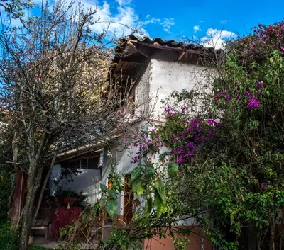 a house with flowers on the side of it at Eco Lodge Los Perales-Urubamba in Urubamba