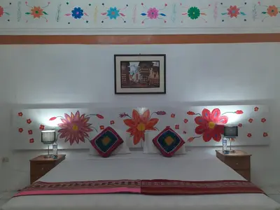 a bedroom with a bed with flowers on the wall at Reinbo Garden in Cusco