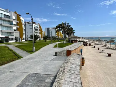a sidewalk next to the beach with buildings at 1 Fila Vista Bahía Paracas - La Velas 501 T1 in Paracas