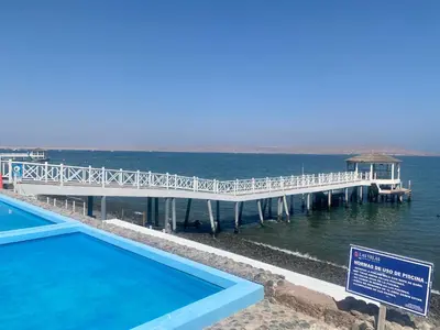 a pier with a swimming pool next to the water at 1 Fila Vista Bahía Paracas - La Velas 501 T1 in Paracas