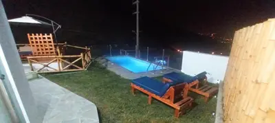 a backyard with a swimming pool at night at Tranquilidad y Sol in Cieneguilla