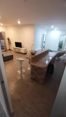 a living room with a large room with a table and a couch at Tranquilidad y Sol in Cieneguilla