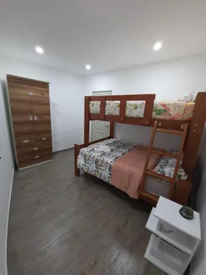a bedroom with a bunk bed and a dresser at Tranquilidad y Sol in Cieneguilla