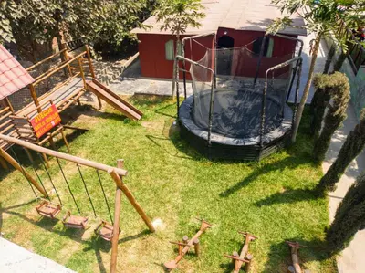 a group of playground equipment in a yard at Amachito's Casa Recreacional in Lima