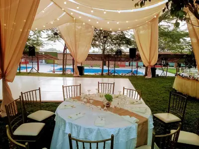 a table set up for a wedding under a tent at Amachito's Casa Recreacional in Lima