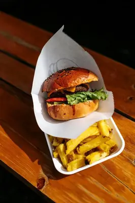 a sandwich and french fries in a container on a table at VPX Hoteles Cieneguilla in Cieneguilla