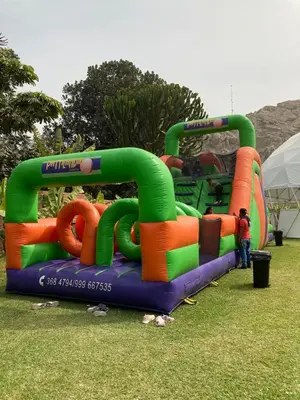 a large inflatable water slide in a park at VPX Hoteles Cieneguilla in Cieneguilla