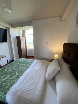 a bedroom with a large bed and a couch at Casa Yanahuara Valle Sagrado - Urubamba in Urubamba