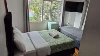 a small bedroom with a bed and a window at Casa Yanahuara Valle Sagrado - Urubamba in Urubamba