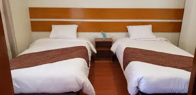 two beds sitting next to each other in a room at Tilcafé B&B Mollepata in Mollepata