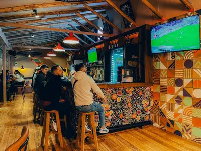 a group of people sitting at a bar at Viajero Cusco Hostel in Cusco