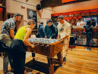 a group of people playing a game of foosball at Viajero Cusco Hostel in Cusco