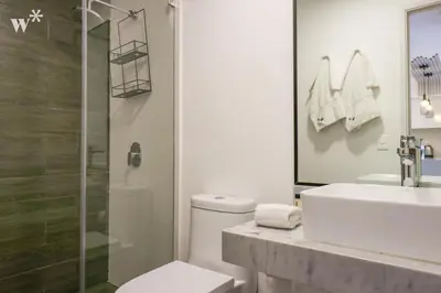 a bathroom with a toilet and a sink and a shower at Alta by Wynwood House in Lima