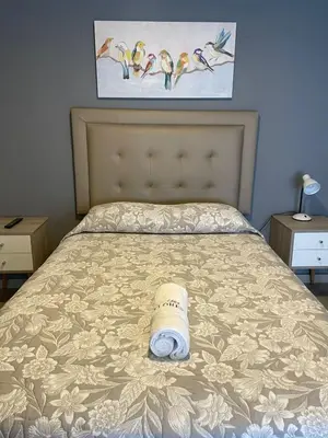 a bed with a roll of toilet paper on it at Casa Las Flores Ica in Ica