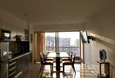 a kitchen and dining room with a table and chairs at Terrazas Apartments Miraflores in Lima