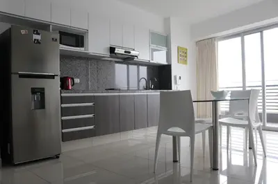 a kitchen with a refrigerator and a table and chairs at Terrazas Apartments Miraflores in Lima