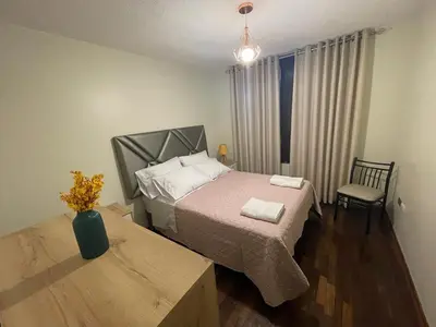 a bedroom with a bed and a table and a chair at Departamento completo Surquillo/Miraflores in Lima