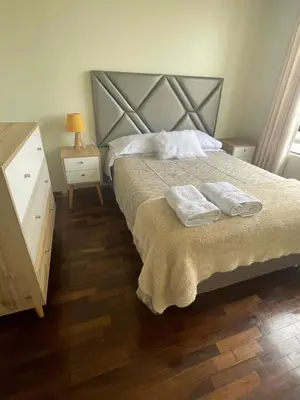a bedroom with a bed with two towels on it at Departamento completo Surquillo/Miraflores in Lima