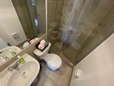 a bathroom with a shower and a toilet and a sink at Departamento completo Surquillo/Miraflores in Lima
