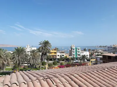 a view of the roofs of a city with palm trees at Icthus Paracas in Paracas
