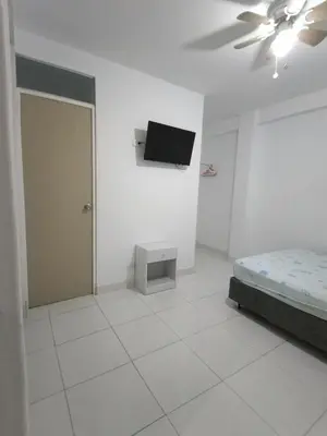 a bedroom with a bed and a tv on the wall at Icthus Paracas in Paracas
